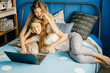 © Cavan Images - two beautiful women twins do the work as a freelance laptop