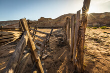 An Old Wooden Fence In The Desert At Sunrise.