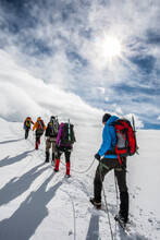 Group Of Alpinist Walking In Line