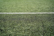 © Rolands - green artificial football pitch with white line