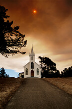 Smoke Blocks Out The Sun Over A Country Church In California.