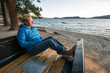 © Cavan Images - Woman sitting in renovated truck watching sunset, Payette Lake, McCall, Idaho, USA