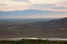 Dusk Over Medano Creek And The San Luis Valley In Great Sand Dunes National Park And Preserve, Colorado.