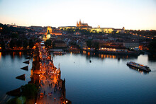 View Over Charles Bridge The Castle And St. Vitus Cathedral At Night, Prague, Czech Republic.
