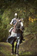 Man On Horseback Dressed As Medieval Warrior.