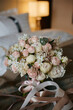 Bridal bouquet of fresh roses and peonies flowers and green branches