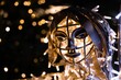 Metallic face of an angel with Christmas lights inside and behind