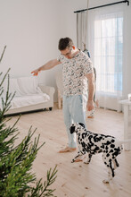Man Telling His Dalmatian Off At Home 