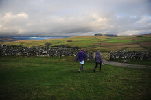 Two Girls Walk Towards Pen Y Ghent In The Yorkshire Dales