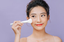 Beauty Asian Woman Applying Makeup With Brush Of Cheek Isolated