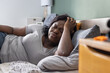 © Anna Berkut/Stocksy - malaise, hangover or headache, sick woman feeling bad in the bedroom