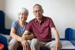 © Anna Berkut/Stocksy - senior old asian couple smiling portrait sitting together at home