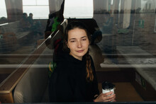 Young Woman's Portrait Through A Glass Inside Of A Sea Ferry