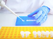 Laboratory scientist working at lab with micro pipette and test tubes. Laboratory concept woman technician chemist. Medical diagnostics, research and science background.