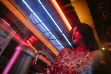 Low-angle Portrait Of An Asian Woman At Night