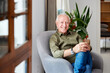 © ALTO IMAGES/Stocksy - Happy elderly man sitting in living room