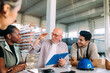 © Studio Firma/Stocksy - Group of Workers in Factory
