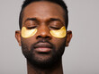 © ohlamour studio/Stocksy - Man using beauty eye mask