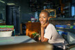 © Jovo Jovanovic/Stocksy - Portrait of smiling female sitting at restaurant