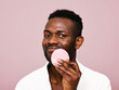 © ohlamour studio/Stocksy - Happy man using skin care products