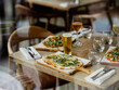 © Andrew Urwin/Stocksy - A selection of pizza on a wooden table in a pub