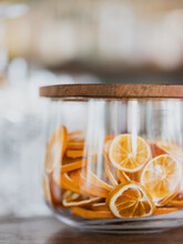 A Jar Of Dried Orange Slices On A Bar