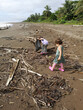 © Gemma can fly/Stocksy - Kids doing Beach Cleanup collecting plastic UGC