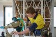 © Rowena Naylor/Stocksy - Apprentice tradie at work