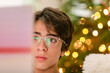 © ByLorena/Stocksy - Teen Boy on clear glasses watching laptop during Christmas portrait