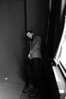 © Oleksii Syrotkin/Stocksy - Male model leans against wall in studio