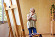 © ALTO IMAGES/Stocksy - Cheerful senior artist in home studio