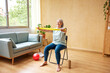 © ALTO IMAGES/Stocksy - Smiling elderly woman exercising with elastic band