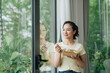 © Marc Tran/Stocksy - Asian woman eating salad during lunch break at her desk in office