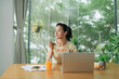 © Marc Tran/Stocksy - Woman eating healthy vegetable salad in office
