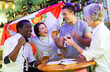 © JackF - Excited diverse soccer fans with flag of Peru rejoicing winning game with glasses of beer in the pub