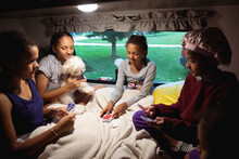Children In A Camper Trailer Playing A Game Of Cards