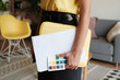 © Malquerida Studio/Stocksy - Anonymous woman holding folder and documents