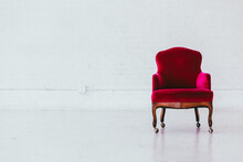 Vintage Red Velvet Wingback Chair In A White Brick Studio