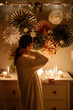 © Sergey Narevskih/Stocksy - Anonymous woman in room decorated for Christmas