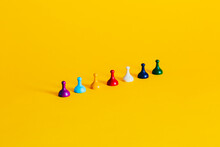Colorful Board Game Pieces On A Vibrant Yellow Background
