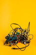 © Carter Wright/Stocksy - A messy bundle of tangled electronic cords and wires