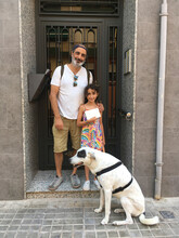 Family With Dog Posing At Their Home Street Door UGC