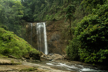 Large Waterfall Cascades Through Rocks In The Rainforest 