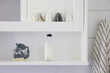 © Trinette Reed/Stocksy - Farmhouse bathroom shelf with soap and bath product