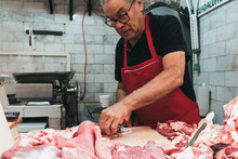Butcher Working In His Butchery Shop 