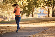 © Drazen - Young athletic woman running during sports training in park.