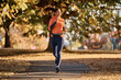 © Drazen - Happy athletic woman jogging on autumn day in nature.