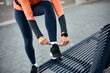 © Drazen - Close up of athlete tying shoelace while getting ready for exercising outdoors.