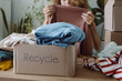 © Duet Postscriptum/Stocksy - Old clothes in a cardboard box before being sent for recycling