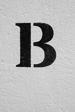 Distressed Brick Wall Background With A Painted Letter B.